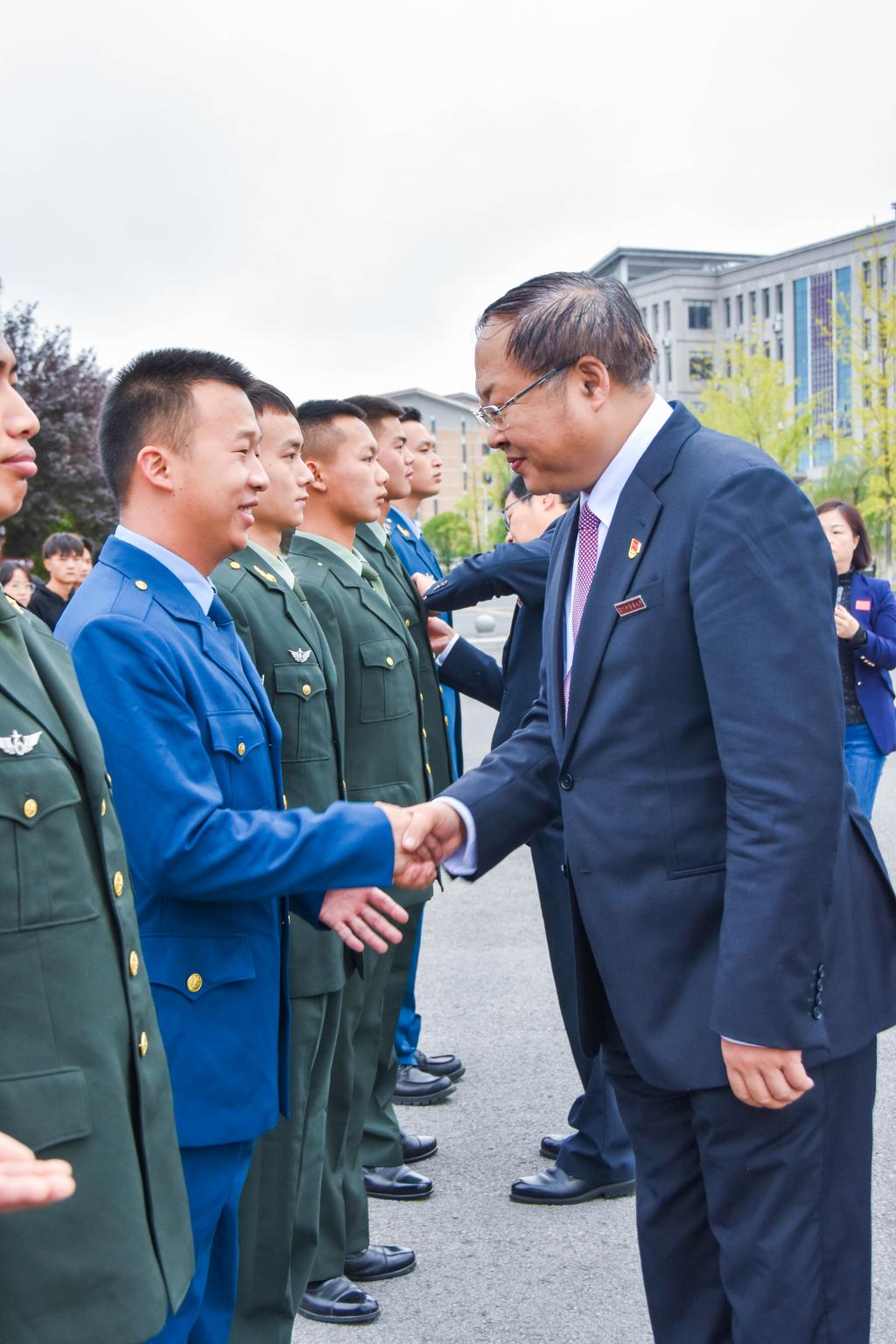 校领导刘兴德,邬卫东,周英为18名退役复学大学生佩戴校徽校党委书记杨